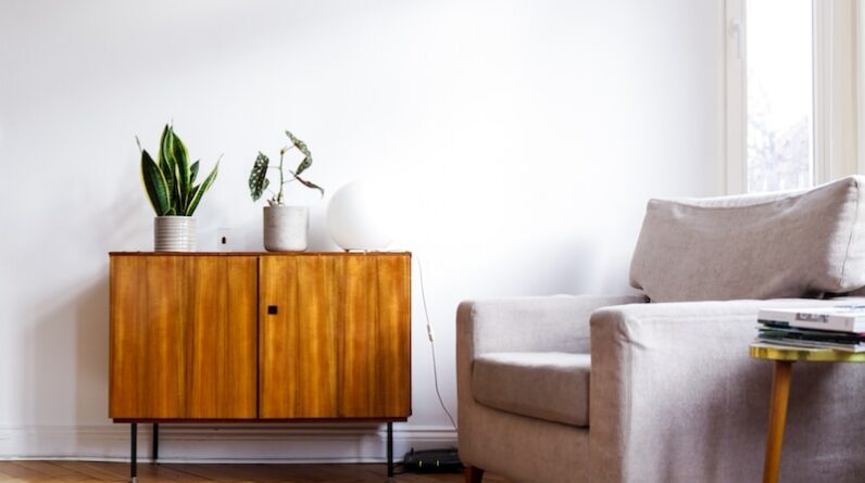 brown wooden table beside gray couch