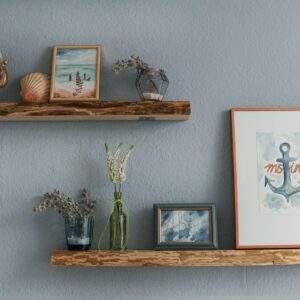 white flowers in clear glass vase on brown wooden wall shelf