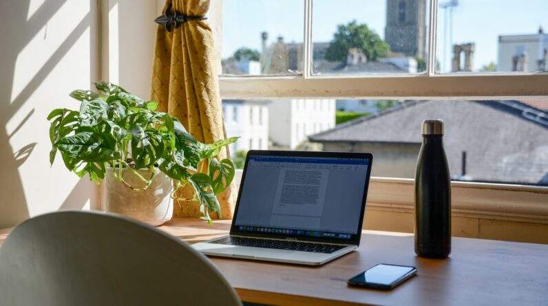 macbook pro on brown wooden table