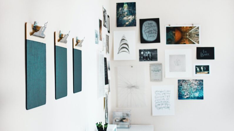 three green clipboards on wall