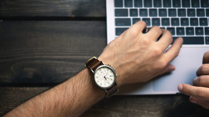 person wearing brown and white watch